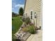 Exterior view of lush landscaping and garden beds along the side of the home on a sunny day at 10955 Chapel Woods N Blvd, Noblesville, IN 46060