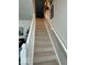 Carpeted staircase with white railing, offering a clear path to the next level of the home at 10955 Chapel Woods N Blvd, Noblesville, IN 46060