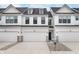 Charming townhome featuring a white exterior, attached garage, and well-maintained landscaping at 10965 Morab Dr, Zionsville, IN 46077