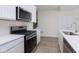 Well-equipped kitchen boasting stainless steel appliances, white cabinets, and quartz countertops at 10965 Morab Dr, Zionsville, IN 46077