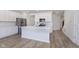Open concept kitchen featuring an island, stainless steel appliances, and hardwood flooring at 10965 Morab Dr, Zionsville, IN 46077
