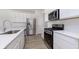 Modern kitchen with stainless steel appliances, quartz countertops, and white cabinetry at 10965 Morab Dr, Zionsville, IN 46077