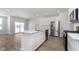 Bright kitchen featuring a center island, stainless steel appliances, and hardwood flooring at 10965 Morab Dr, Zionsville, IN 46077