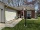 Cozy home with brick facade and a charming porch with a view, featuring well manicured lawn at 111 Woodberry Dr, Danville, IN 46122