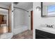 Bright bathroom with a combination tub and shower, a dark vanity with sink, and neutral-toned flooring at 1126 N Anderson St, Elwood, IN 46036