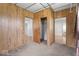Bedroom features carpeted floors, wood-paneled walls, and doorways to other areas of the house at 1126 N Anderson St, Elwood, IN 46036