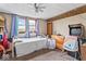 Bright bedroom featuring a ceiling fan and natural light from the large window at 1126 N Anderson St, Elwood, IN 46036