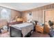Cozy bedroom with wood paneled walls at 1126 N Anderson St, Elwood, IN 46036