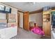 Bedroom showing an open door, carpeted floors, and items stored in boxes and on shelves at 1126 N Anderson St, Elwood, IN 46036
