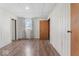 Bedroom featuring wood-look floors, white walls, and a window dressed with patterned curtains at 1126 N Anderson St, Elwood, IN 46036