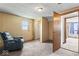 Neutral bedroom with window, chair, and access to closet and another room at 1126 N Anderson St, Elwood, IN 46036