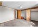 A mostly unfurnished carpeted bedroom with a ceiling fan and two doorways at 1126 N Anderson St, Elwood, IN 46036
