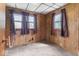 Carpeted bedroom with wood paneling, two windows, and curtains at 1126 N Anderson St, Elwood, IN 46036