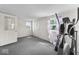 Bedroom with gray carpet, two doors and purple-and-white striped curtains at 1126 N Anderson St, Elwood, IN 46036