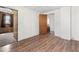Bedroom featuring wood-look floors, white walls, and an open doorway to an adjacent room at 1126 N Anderson St, Elwood, IN 46036