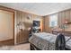 This bedroom features wood paneling and a large window, offering a cozy and bright space at 1126 N Anderson St, Elwood, IN 46036
