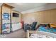 A bedroom featuring wood paneling, carpeted floors, and a comfortable recliner near the bed at 1126 N Anderson St, Elwood, IN 46036