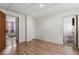 Bedroom with wood-look floors, white walls, and multiple doorways to adjoining spaces at 1126 N Anderson St, Elwood, IN 46036