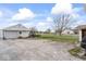 Exterior view of garage and shed, situated in a large yard on a partly cloudy day at 1126 N Anderson St, Elwood, IN 46036
