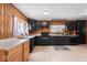 Large kitchen with wood paneling, black cabinets, vinyl flooring and two toned cabinets at 1126 N Anderson St, Elwood, IN 46036
