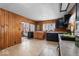 Kitchen with wood paneling, black cabinets and vinyl flooring at 1126 N Anderson St, Elwood, IN 46036