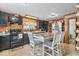 Charming kitchen with black cabinets and wood-paneled walls and a table with seating at 1126 N Anderson St, Elwood, IN 46036