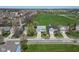 Aerial view of a neighborhood with well-maintained lawns and a large grassy field nearby at 12258 Weathered Edge Dr, Fishers, IN 46037