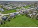 This aerial shows a neighborhood with mature landscaping and recreational fields at 12258 Weathered Edge Dr, Fishers, IN 46037