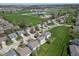 This is an aerial view of homes in a neighborhood with mature landscaping and a school at 12258 Weathered Edge Dr, Fishers, IN 46037