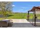 Backyard patio featuring a gazebo, fire pit, and seating area overlooking a large open field at 12258 Weathered Edge Dr, Fishers, IN 46037