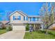Charming two-story home with blue shutters, a well-maintained lawn, and a blossoming tree at 12258 Weathered Edge Dr, Fishers, IN 46037