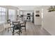 Open concept kitchen and dining area with white cabinets, appliances, and laminate flooring at 12258 Weathered Edge Dr, Fishers, IN 46037