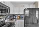 Well-lit kitchen with white cabinets, stainless steel appliances, and a modern backsplash at 12258 Weathered Edge Dr, Fishers, IN 46037
