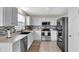 Well-lit kitchen with white cabinetry, stainless steel appliances, and modern backsplash at 12258 Weathered Edge Dr, Fishers, IN 46037