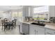 Bright kitchen with white cabinets, stainless steel appliances, and a dining area nearby at 12258 Weathered Edge Dr, Fishers, IN 46037