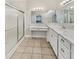 Bright bathroom featuring marble countertops, dual sinks, vanity, and glass-enclosed shower at 12521 Hawks Landing Dr, Fishers, IN 46037