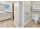 Bright bathroom features a sleek vanity and shower and a convenient storage cabinet above the toilet at 12521 Hawks Landing Dr, Fishers, IN 46037