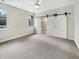 Bright bedroom with a ceiling fan and sliding barn door at 12521 Hawks Landing Dr, Fishers, IN 46037