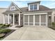 Two-story home featuring a brick and siding front, two-car garage and landscaped front yard at 12521 Hawks Landing Dr, Fishers, IN 46037
