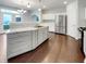 Modern kitchen with stainless steel appliances, marble countertops, and white cabinetry at 12521 Hawks Landing Dr, Fishers, IN 46037