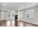 Open concept living room with hardwood floors, stone fireplace, and large windows at 12521 Hawks Landing Dr, Fishers, IN 46037