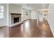 Open living room boasts a stone fireplace and hardwood floors at 12521 Hawks Landing Dr, Fishers, IN 46037