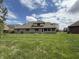 Expansive backyard showcasing the home's brick exterior and well-manicured lawn at 1304 Park Meadow Dr, Beech Grove, IN 46107