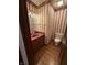 Retro powder room featuring a vanity with a red sink and brass lighting fixtures at 1304 Park Meadow Dr, Beech Grove, IN 46107