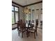 Formal dining room with wood table, chandelier, and mirrored walls at 1304 Park Meadow Dr, Beech Grove, IN 46107