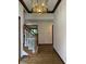 Entryway of home featuring hardwood floors, staircase, and chandelier at 1304 Park Meadow Dr, Beech Grove, IN 46107