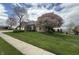 A brick home with a three car garage and mature trees at 1304 Park Meadow Dr, Beech Grove, IN 46107