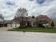 A brick home with a three car garage and mature trees at 1304 Park Meadow Dr, Beech Grove, IN 46107