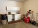 Well-organized garage with white cabinets, counter space, and room for projects and storage at 1304 Park Meadow Dr, Beech Grove, IN 46107