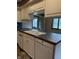 Close-up of the kitchen sink and dishwasher, with tiled countertops at 1304 Park Meadow Dr, Beech Grove, IN 46107